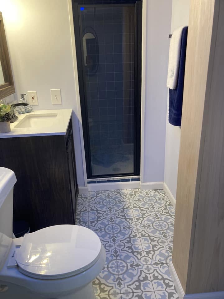 Renovated basement bathroom with new tile flooring